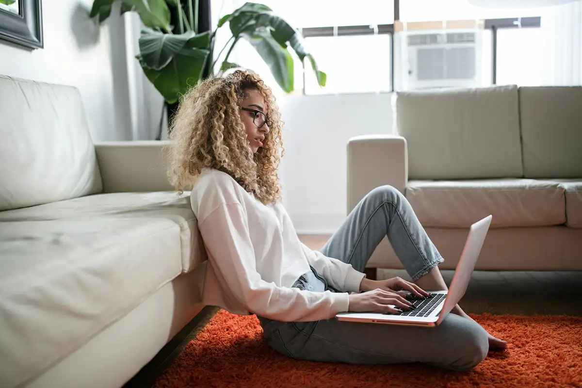 A woman checks on her Section 8 Status on her laptop.