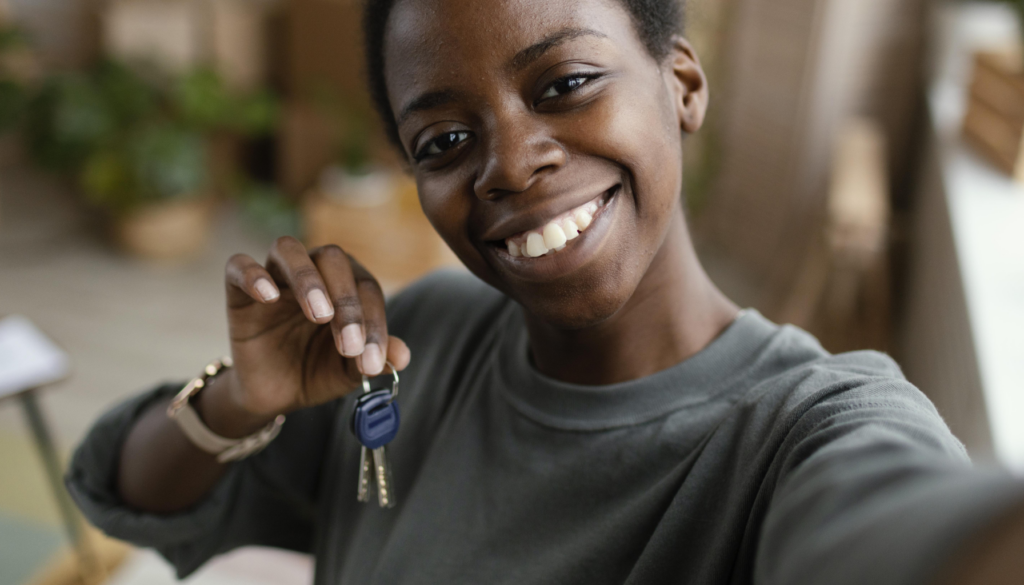 a woman gets keys to her house after fighting discrimination